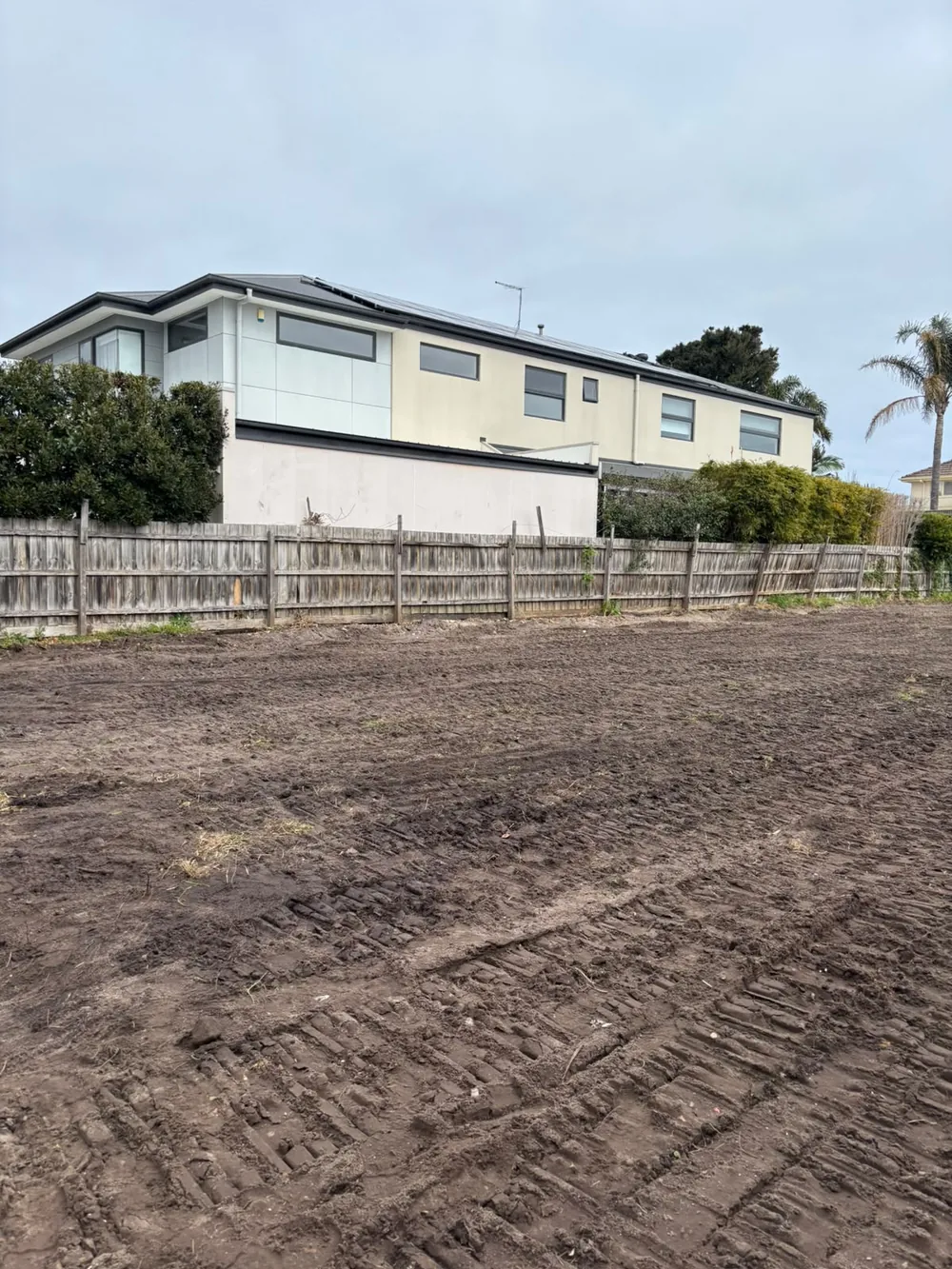 Cleared residential block and its boundary fencing after site works